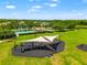Community playground with sunshades, benches, modern equipment, and views of pond at 17342 Lawn Orchid Loop, Land O Lakes, FL 34638