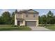 Charming two-story home with a front yard, a driveway, an attached garage, and neutral-tone siding at 17597 Happytrails St, Land O Lakes, FL 34638