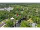 A home nestled among trees, with direct access to the waterfront, seen from an aerial perspective at 18202 Abbey Ln, Lutz, FL 33548