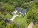 A well-manicured house is captured aerially showcasing the driveway, landscaping, and nearby street at 18202 Abbey Ln, Lutz, FL 33548