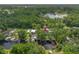 Gorgeous aerial shot of the property with waterfront access, lush greenery, and private boat dock at 18202 Abbey Ln, Lutz, FL 33548