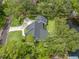 Aerial view highlighting a home's roof, lawn, and proximity to the water, illustrating its setting at 18202 Abbey Ln, Lutz, FL 33548