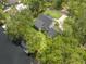 Aerial view of home surrounded by mature trees and water, illustrating its private and picturesque location at 18202 Abbey Ln, Lutz, FL 33548