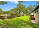 Spacious backyard with lush lawn and a covered dock by the water, creating a peaceful outdoor retreat at 18202 Abbey Ln, Lutz, FL 33548