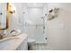 Elegant bathroom featuring a glass shower, marble vanity top, and mosaic tiled floor at 18202 Abbey Ln, Lutz, FL 33548