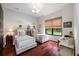 This bedroom features hardwood floors, a window, and two beds at 18202 Abbey Ln, Lutz, FL 33548
