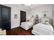 Charming bedroom featuring two twin beds with elegant bedding and dark wood floors at 18202 Abbey Ln, Lutz, FL 33548