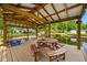 Covered boat dock featuring a wooden picnic table, overhead lighting, and waterfront views at 18202 Abbey Ln, Lutz, FL 33548