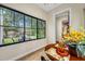 Bright breakfast nook featuring a round table, wood flooring, and a large window with scenic backyard views at 18202 Abbey Ln, Lutz, FL 33548