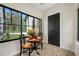 Cozy breakfast nook with wood-look tile, table for two, and a large window showcasing the lush lawn at 18202 Abbey Ln, Lutz, FL 33548