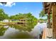 A serene waterfront view featuring a private dock with a covered seating area at 18202 Abbey Ln, Lutz, FL 33548
