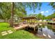 Beautiful wooden dock with a covered seating area perfect for enjoying waterfront views and relaxing outdoors at 18202 Abbey Ln, Lutz, FL 33548