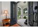 A view of the entryway showcasing the beautiful metal door and outdoor patio at 18202 Abbey Ln, Lutz, FL 33548
