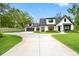 Beautiful two-story home with manicured lawn, circular driveway, attached garage, and shutters at 18202 Abbey Ln, Lutz, FL 33548