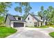 Charming two-story home with a modern farmhouse style, landscaped front yard, and separate garage at 18202 Abbey Ln, Lutz, FL 33548