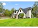 Charming two-story home with a modern farmhouse style, well-manicured lawn, and inviting curb appeal at 18202 Abbey Ln, Lutz, FL 33548