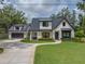 Charming two-story home with a well-manicured lawn, beautiful curb appeal, and an attached garage at 18202 Abbey Ln, Lutz, FL 33548