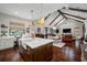 Bright, open kitchen with a large island, farmhouse sink, and view of the living area at 18202 Abbey Ln, Lutz, FL 33548