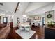 Open kitchen and dining area with beautiful chandelier, dark wood floors, and a large kitchen island at 18202 Abbey Ln, Lutz, FL 33548