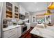 Updated kitchen with stainless steel appliances, light gray cabinetry, and marble countertops at 18202 Abbey Ln, Lutz, FL 33548