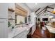 Bright kitchen features custom desk and shelving, marble countertops, and open floor plan with vaulted ceilings at 18202 Abbey Ln, Lutz, FL 33548