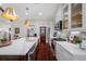 Updated kitchen featuring a large island with farmhouse sink, marble countertops, and stainless steel appliances at 18202 Abbey Ln, Lutz, FL 33548