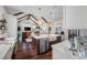 Open concept kitchen with stainless steel appliances, island with sink, breakfast bar, and wood flooring at 18202 Abbey Ln, Lutz, FL 33548