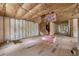 Unfinished living room showcasing wood flooring and exposed insulation, ready for customization at 18202 Abbey Ln, Lutz, FL 33548