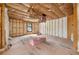 Living room displays unfinished walls and insulation, providing a blank canvas for renovation at 18202 Abbey Ln, Lutz, FL 33548