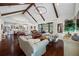 Spacious living room with vaulted ceilings, wood beams, chandelier, and an open concept floor plan at 18202 Abbey Ln, Lutz, FL 33548