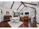 Bright, open-concept living space with vaulted ceilings, hardwood floors, stylish furniture, and elegant chandeliers at 18202 Abbey Ln, Lutz, FL 33548