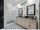 This main bathroom features dual sinks, modern floors, and a glass-enclosed shower at 18202 Abbey Ln, Lutz, FL 33548