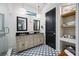 A view of the main bathroom featuring dual sinks, modern floors, and a shower at 18202 Abbey Ln, Lutz, FL 33548