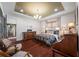 This main bedroom features a hardwood floor, light colored walls and nice furniture at 18202 Abbey Ln, Lutz, FL 33548