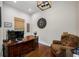 Home office space with dark wood desk, patterned chair, and natural light at 18202 Abbey Ln, Lutz, FL 33548