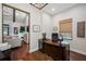 Home office with wooden desk, chair, and view into a connected living space at 18202 Abbey Ln, Lutz, FL 33548