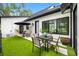 A modern patio with sleek outdoor seating and an umbrella, offering a comfortable space for entertaining and relaxation at 18202 Abbey Ln, Lutz, FL 33548
