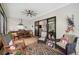 Relaxing screened-in patio with ceiling fan, dining table, comfortable seating, and beautiful backyard views at 18202 Abbey Ln, Lutz, FL 33548