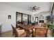 Comfortable screened-in patio featuring wood table, fireplace, and sliding glass doors leading to the interior at 18202 Abbey Ln, Lutz, FL 33548