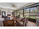 Inviting screened-in patio includes a cozy fireplace, comfortable seating, dining space, and scenic backyard views at 18202 Abbey Ln, Lutz, FL 33548