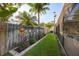 Charming backyard featuring a decorative fence adorned with beer signs and a well-manicured lawn at 2043 Wrangler Dr, Brandon, FL 33511