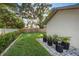 Landscaped backyard with lush greenery, plants, and a well-maintained lawn, creating a serene outdoor space at 2043 Wrangler Dr, Brandon, FL 33511