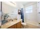 Bright bathroom featuring a sink, tub, shower with blue patterned curtain, and a large mirror at 2043 Wrangler Dr, Brandon, FL 33511