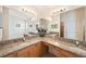 Bright bathroom featuring granite countertop, dual sinks, vanity, and large mirror at 2043 Wrangler Dr, Brandon, FL 33511
