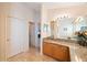 Bright bathroom featuring granite countertop and sink with doorways into other rooms at 2043 Wrangler Dr, Brandon, FL 33511