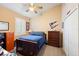 Comfortable bedroom with a ceiling fan, wooden bed, and window with plantation shutters at 2043 Wrangler Dr, Brandon, FL 33511