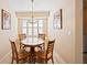 Charming dining area with wood table and chairs illuminated by a decorative pendant light fixture at 2043 Wrangler Dr, Brandon, FL 33511