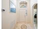 Inviting foyer with tiled floor, chandelier, and abundant natural light from transom window at 2043 Wrangler Dr, Brandon, FL 33511