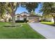 Charming single-Gathering home with a well-maintained lawn, mature trees, and a two-car garage at 2043 Wrangler Dr, Brandon, FL 33511