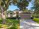 Charming single-Gathering home with a well-maintained lawn, mature trees, and a two-car garage at 2043 Wrangler Dr, Brandon, FL 33511